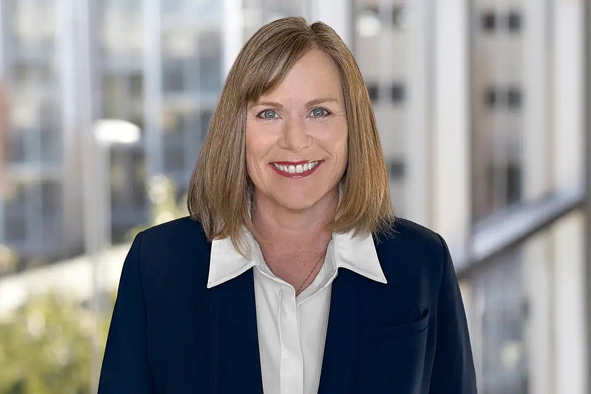 Katrina "Katie" Hagen, CEO of CPS HR Consulting. A woman in a business suit standing in front of a window.