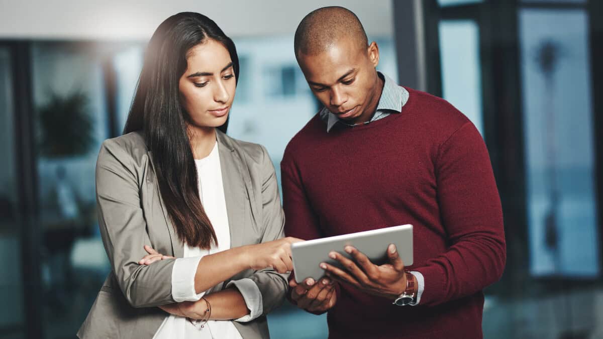 A man and woman looking at a tablet computer