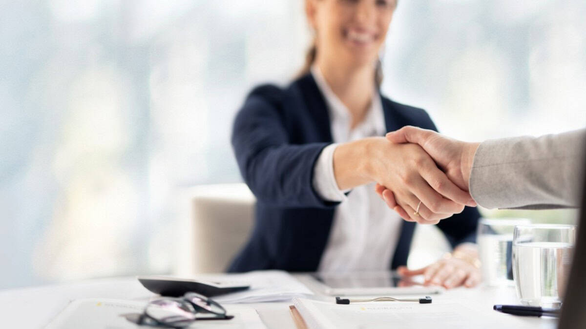 Woman shaking a hand during an interview